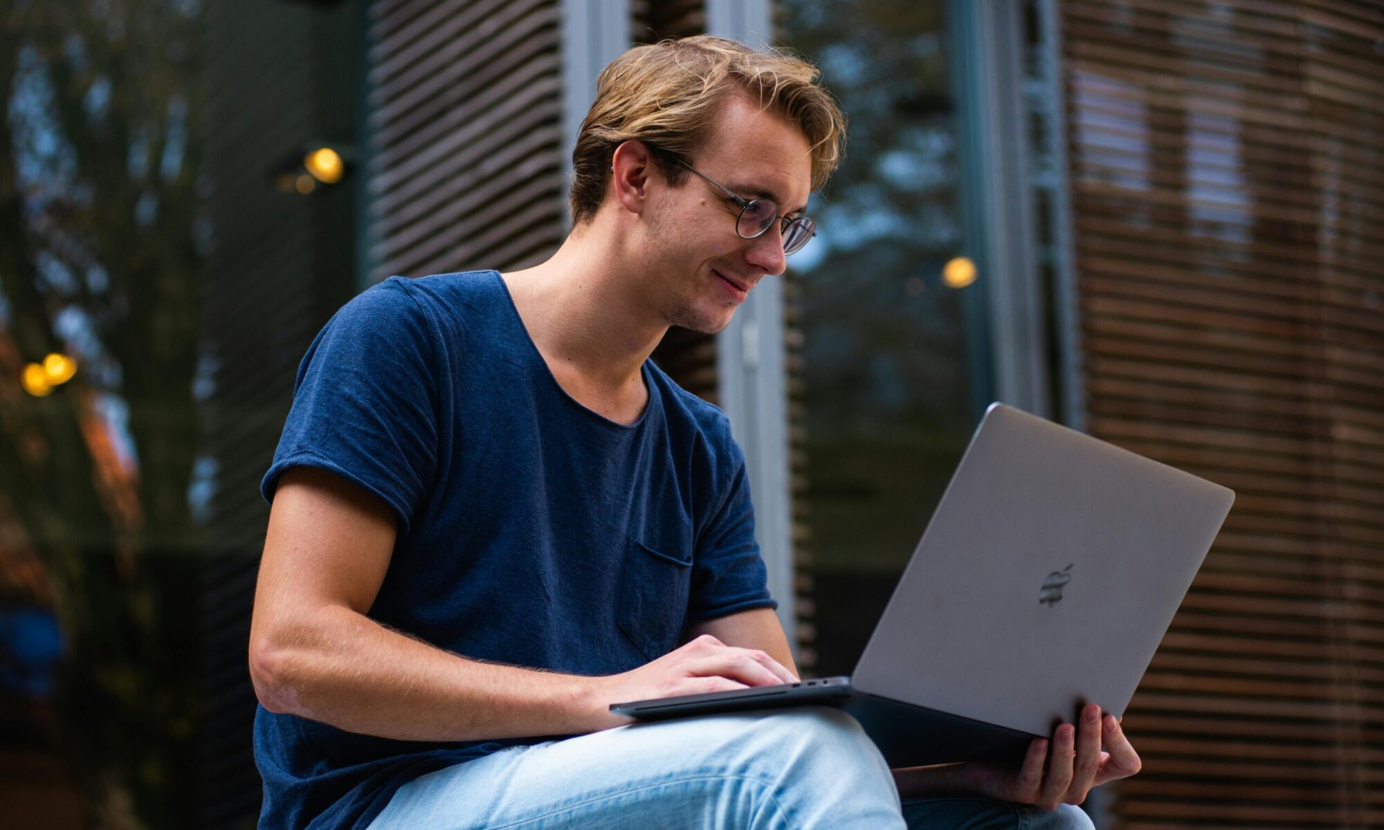 Professional using a laptop outdoors, representing laptop rental solutions for students, freelancers, remote workers, and businesses
