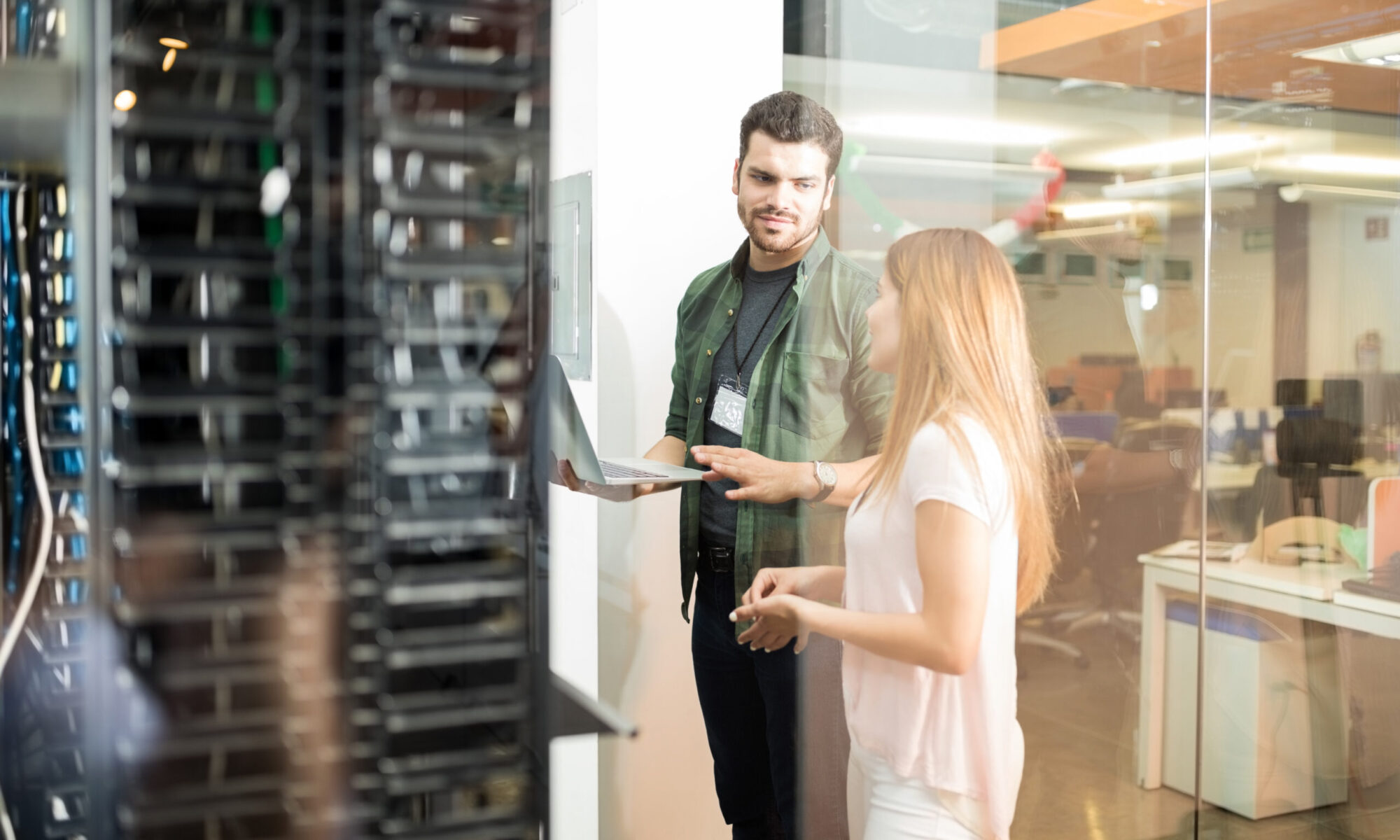 Business professionals discussing server rental solutions in a data center for growing small businesses